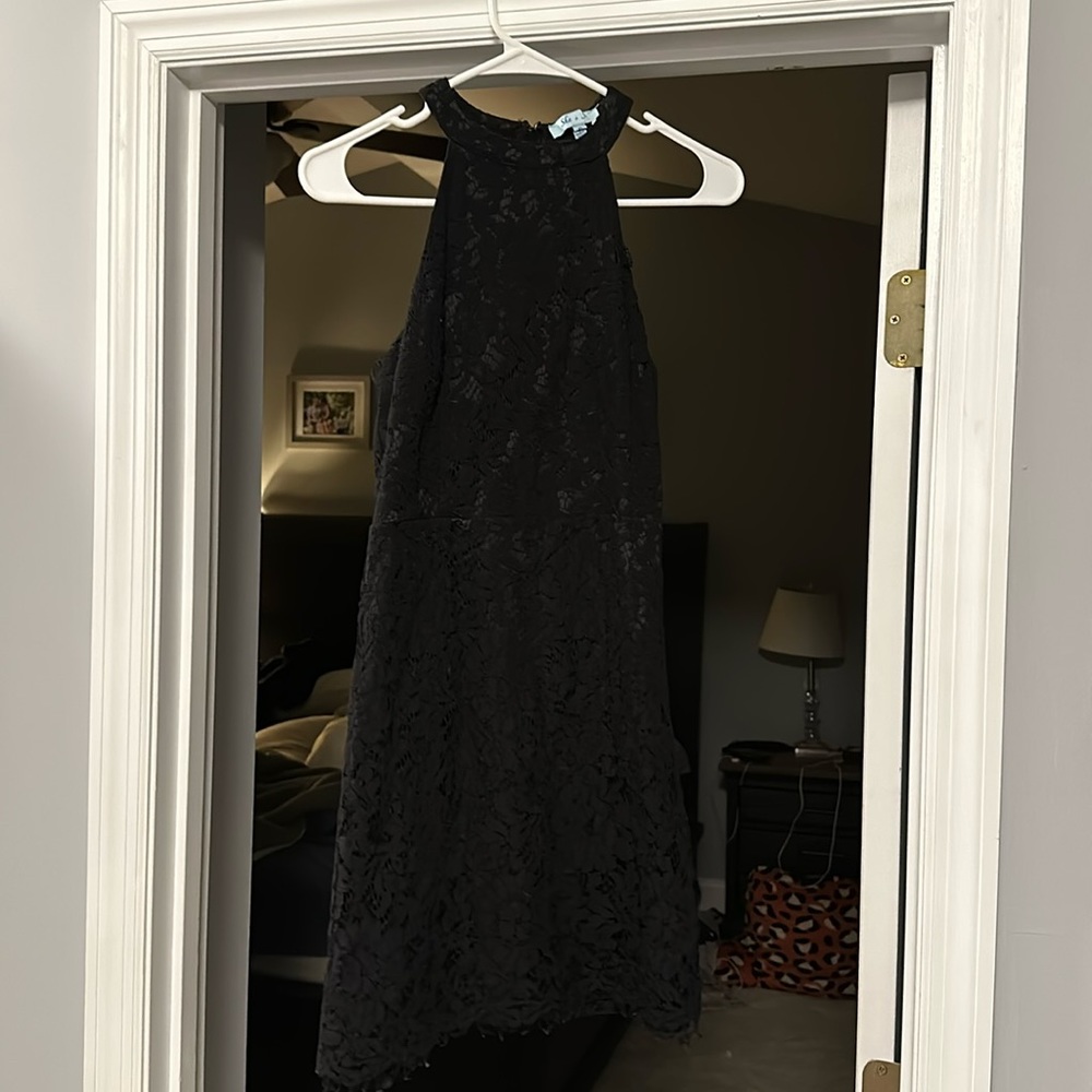 Short, black lace dress with unlined back.